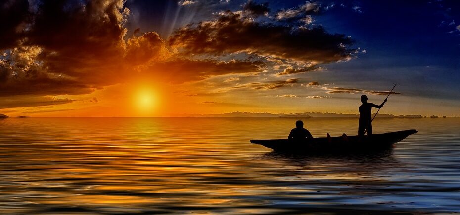 Two souls on a boat at sunset.